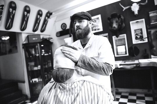 Barber use  towell on face